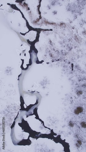 Aerial view of white winter river with  flowing water in Laurentides Canada (ID: 680200776)