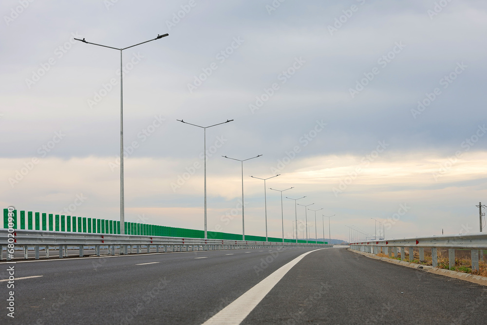 New highway motorway after construction and repair in a cloudy day. New highway motorway after construction and repair in a cloudy day.