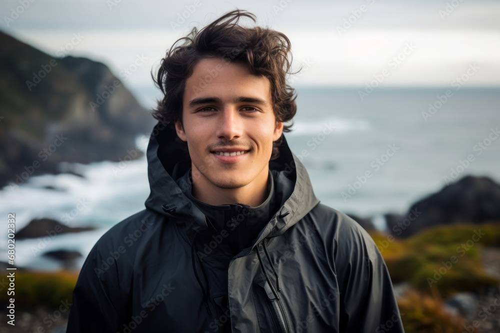 Portrait of a blissful man in his 20s wearing a windproof softshell against a rocky shoreline background. AI Generation Portrait of a blissful man in his 20s wearing a windproof softshell against a rocky shoreline background. AI Generation