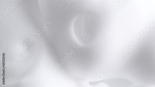 Hair foam mousse, macro. Beauty background. Close up of white cloud of hair mousse or shaving foam. Soap suds photo