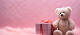 In an isolated corner of a room, a heart-shaped gift box rests on a white tablecloth. Inside, a cute pink bear toy with soft fur peeks out, invoking memories of childhood fun and love. The white
