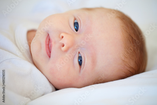 Closeup, portrait and baby for wake up in bedroom for sleep, relax or peaceful in morning. Infant, happy or good dream from nap with calm, care or hope for child growth, cognitive and development