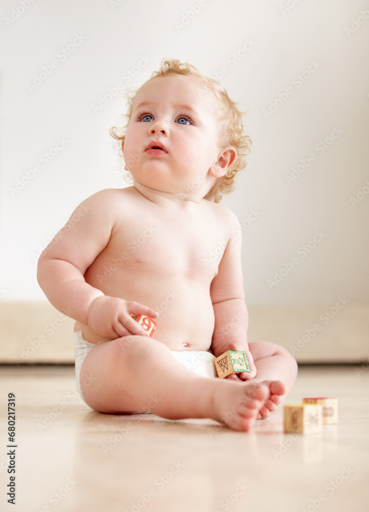 Baby, boy and building blocks on a floor for learning, playing or having fun in a nursery room. Little, cute and curious kid relax with toy for child development, coordination or educational skills Baby, boy and building blocks on a floor for learning, playing or having fun in a nursery room. Little, cute and curious kid relax with toy for child development, coordination or educational skills
