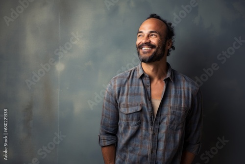 Portrait of a blissful man in his 40s wearing a comfy flannel shirt against a minimalist or empty room background. AI Generation © CogniLens