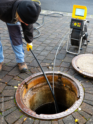 A drain cleaning company checks a blocked drain with a camera before flushing it out photo
