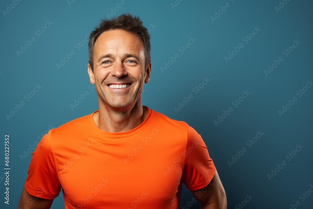 Portrait of a cheerful man in his 40s wearing a moisture-wicking running shirt against a solid color backdrop. AI Generation Portrait of a cheerful man in his 40s wearing a moisture-wicking running shirt against a solid color backdrop. AI Generation