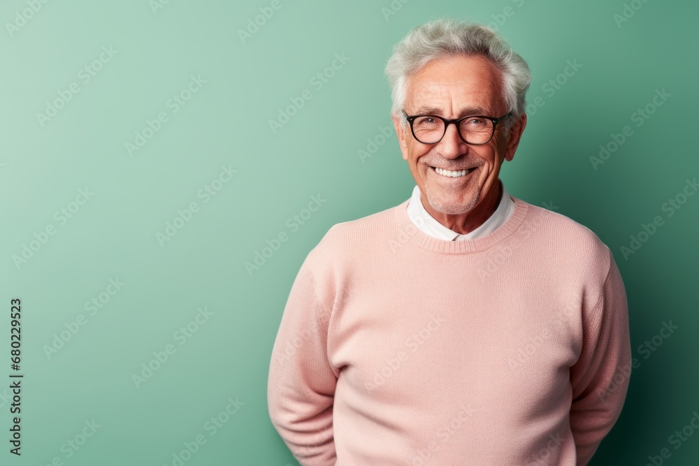 Portrait of a smiling man in his 70s wearing a cozy sweater against a solid pastel color wall. AI Generation Portrait of a smiling man in his 70s wearing a cozy sweater against a solid pastel color wall. AI Generation