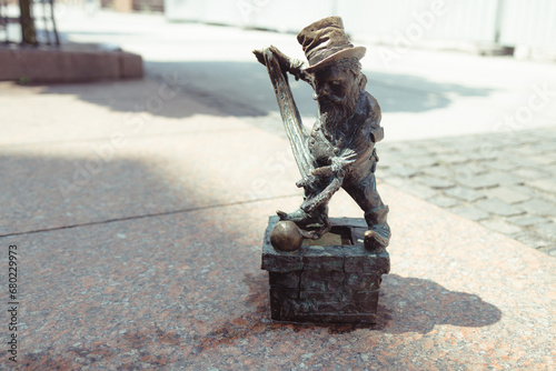 Small dwarf statue on the market square in Wroclaw. High quality photo