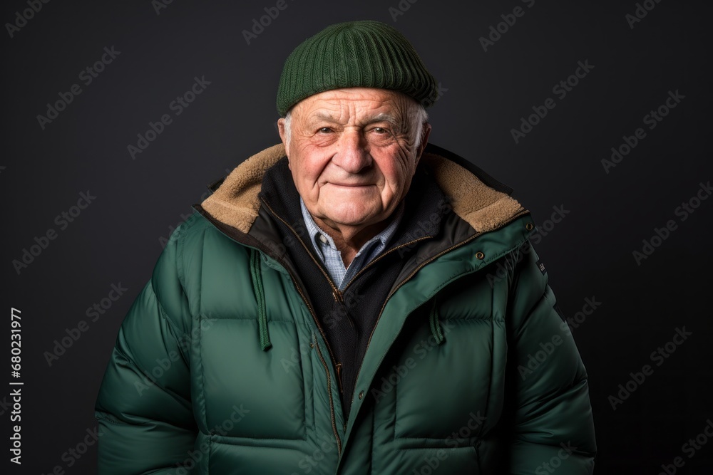 Portrait of a smiling man in his 80s donning a durable down jacket against a blank studio backdrop. AI Generation Portrait of a smiling man in his 80s donning a durable down jacket against a blank studio backdrop. AI Generation