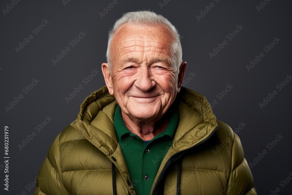 Portrait of a smiling man in his 80s donning a durable down jacket against a blank studio backdrop. AI Generation Portrait of a smiling man in his 80s donning a durable down jacket against a blank studio backdrop. AI Generation