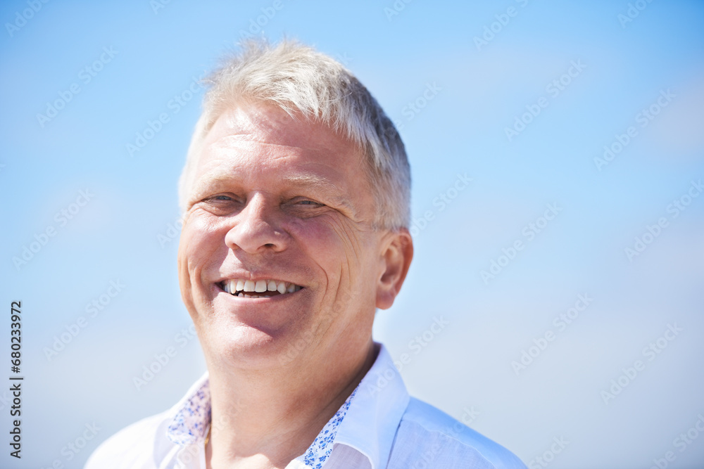 Portrait, smile and happy senior man outdoor for travel, freedom or journey on blue sky background. Face, relax and old male person outside with positive attitude, fresh air or retirement vacation Portrait, smile and happy senior man outdoor for travel, freedom or journey on blue sky background. Face, relax and old male person outside with positive attitude, fresh air or retirement vacation