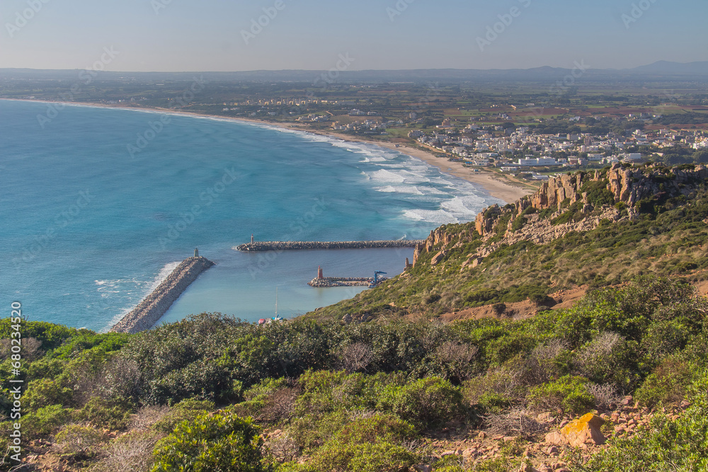 Beach and Mountains under a Blue Sky at Crique Mteris, Haouaria, Tunisia