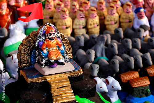 Pune, India, In Maharashtra children build mud forts as an homage to Chhatrapati Shivaji Maharaja, and decorate it with small warrior statues made of soil, which are sold in the market before Diwali. photo