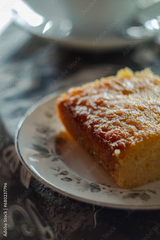 orange cake in the morning in Glasgow Scotland with a decorative white plate
