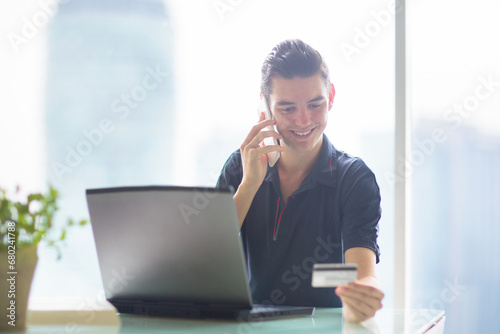 Man with credit card and laptop. Online banking.