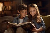 A boy and a girl look at reading a book together