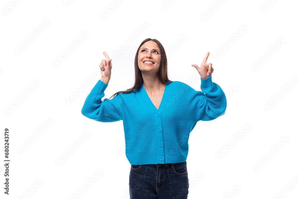 young pretty european brunette woman dressed in a blue button-down sweater actively gesturing on a white background with copy space young pretty european brunette woman dressed in a blue button-down sweater actively gesturing on a white background with copy space