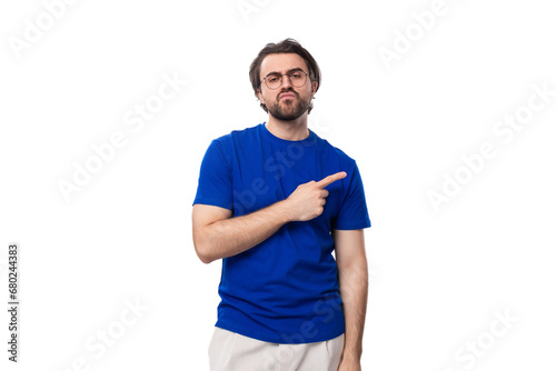 young brunette european man with a beard in a blue t-shirt is inspired by an idea on a white background with copy space