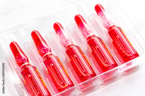 Injection ampoules of hormone B12 in selective focus. Ampoules containing solution for injection used for supplementation of vitamin B12 contain Cyanocobalamin.