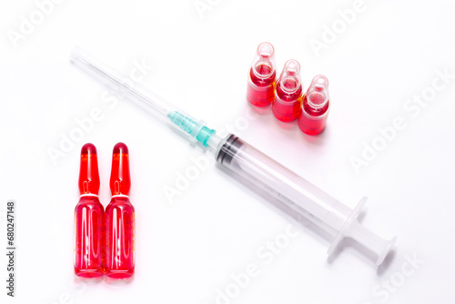B12 hormone injection ampoules in selective focus. Ampoules and syringes containing solution for injection used for vitamin B12 supplementation. Contains cyanocobalamin.
