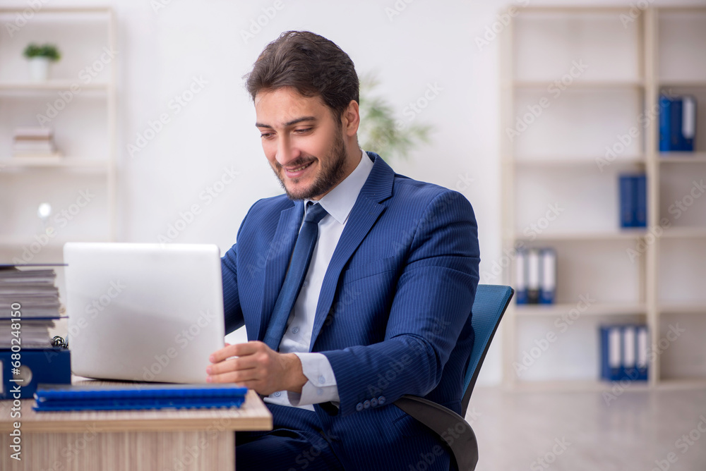 Young male employee working in the office Young male employee working in the office