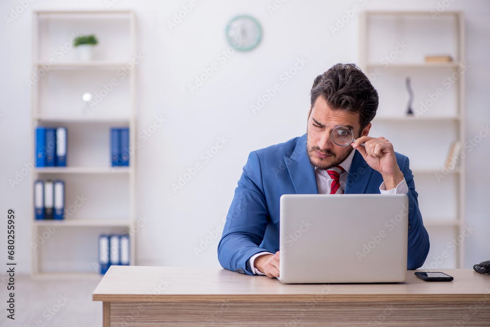 Young male employee working in the office Young male employee working in the office