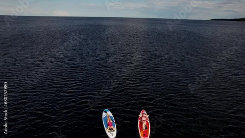 SUP surfing on the water in the summer with girls photo