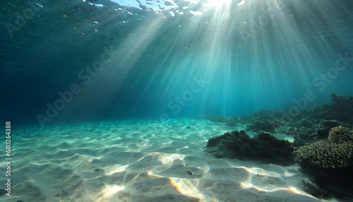 underwater background deep blue sea and beautiful light rays with sandy floor © Alexander