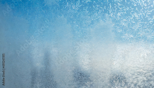 winter background on a transparent glass of a window with a frozen texture abstract texture background horizontal image copy space for your design or text