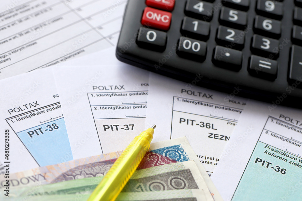 Declaration of the amount of earned income or incurred loss, PIT-36, PIT-36L, PIT-37 and PIT-38 tax forms on accountant table with pen and calculator close up Declaration of the amount of earned income or incurred loss, PIT-36, PIT-36L, PIT-37 and PIT-38 tax forms on accountant table with pen and calculator close up