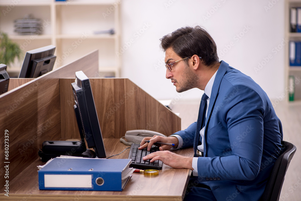 Young male employee working in the office Young male employee working in the office