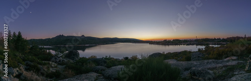 Panorama of evening twilight with Crescent moon over mountain lake after sunset in rocky pure landscape  Vale do Rossim  Serra da Estrela  Portugal