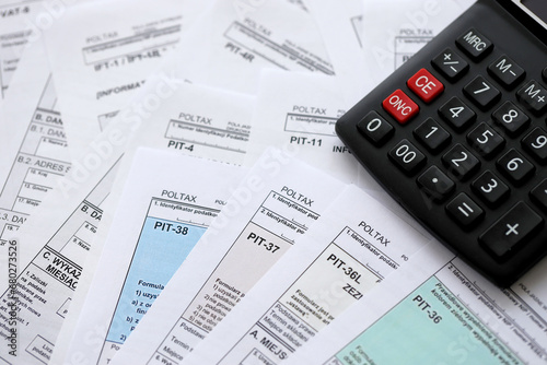 Canvas Print Polish zloty money PLN, calculator and pen on big amount of polish PIT, CIT and VAT tax forms close up