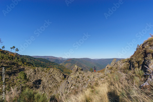 Wallpaper Mural Hikers view over mountain landscape with autumn colored forest over the famous waterfall called Poco do Inferno, Manteigas, Serra da Estrela, Portugal Torontodigital.ca