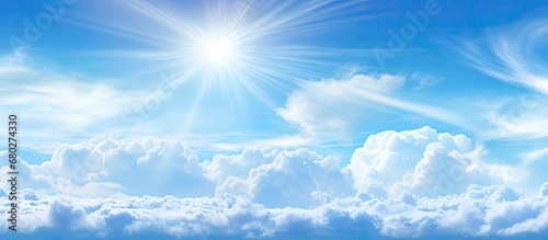 On a beautiful summer day  the clear blue sky stretched out like a boundless expanse of space  as rays of sunlight brushed across the white clouds  creating a mesmerizing display of light and color