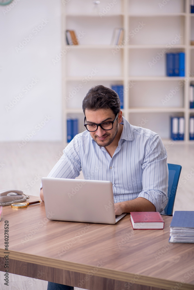 Young male employee working in the office Young male employee working in the office