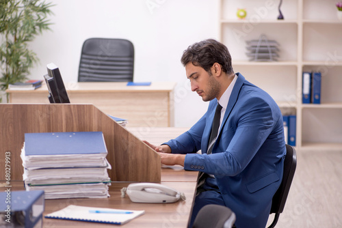 Young male employee working in the office