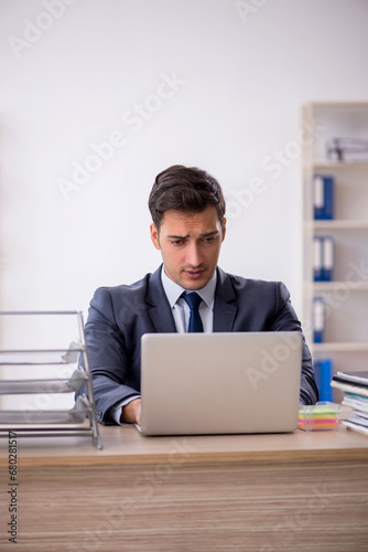 Young male employee working in the office