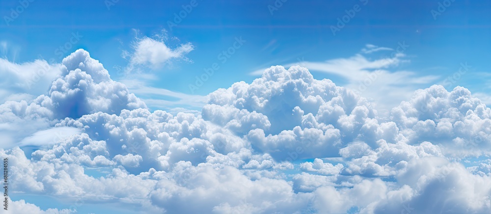 The abstract pattern of white clouds against the blue sky creates a mesmerizing and serene beauty, reminiscent of pastel colors found in natures backgrounds and the limitless expanse of space.