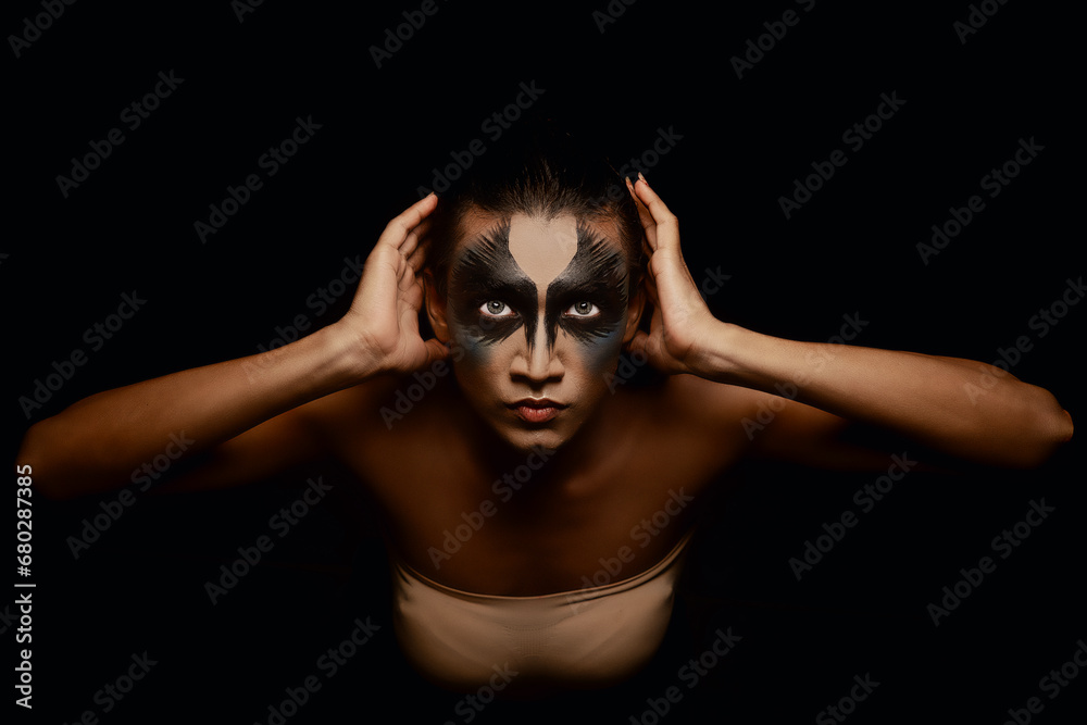 portrait of a person with face painted in black portrait of a person with face painted in black