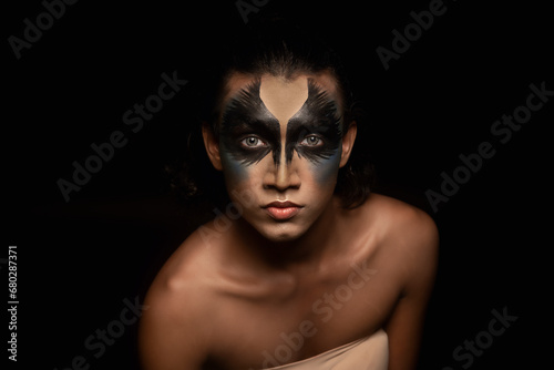 portrait of a person with face painted in black 