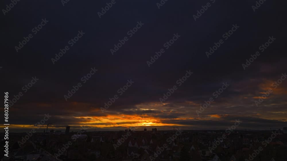Timelapse of sunset on cloudy sky over urban area Timelapse of sunset on cloudy sky over urban area