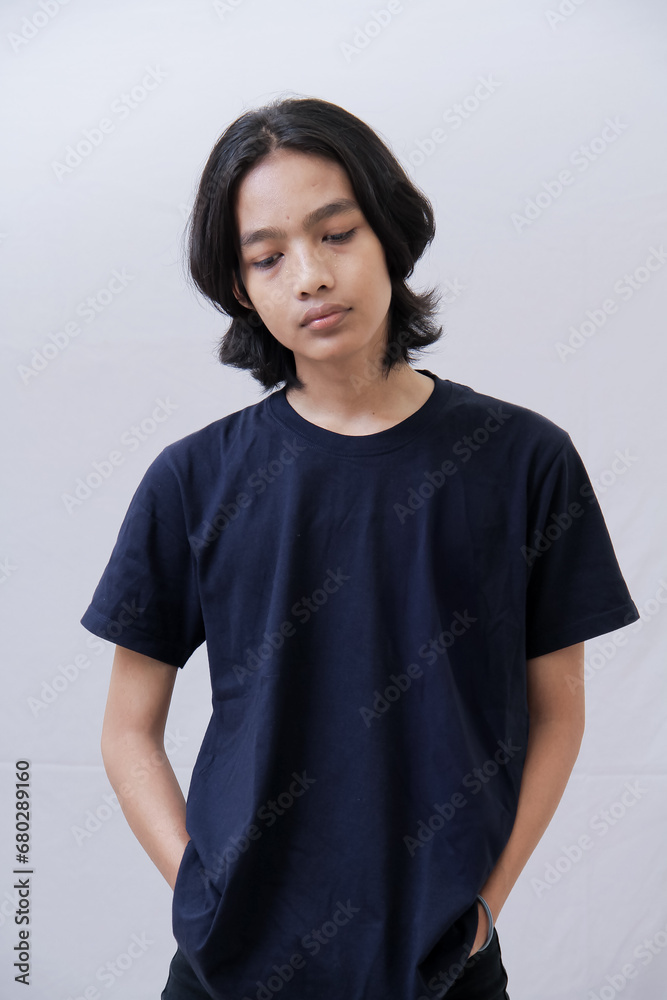 Clothing model. Young Asian man with long curly hair close up shot isolated on white. Asian young man wearing navy blue t-shirt isolated on white background. As if he were modeling a plain t-shirt. Clothing model. Young Asian man with long curly hair close up shot isolated on white. Asian young man wearing navy blue t-shirt isolated on white background. As if he were modeling a plain t-shirt.