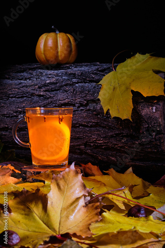 mulled beer with spices and pumpkin on top in halloween concept