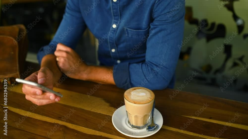 Hands, phone and coffee with a customer in a cafe closeup from above for social media or communication. Mobile, contact or networking and a person in a restaurant with a caffeine beverage to relax