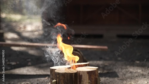 Lighting a Swedish fire for outdoor cooking, a survival skill essential during wartime photo