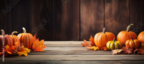 Pumpkins and Autumn Maple Leaves on Wooden Table