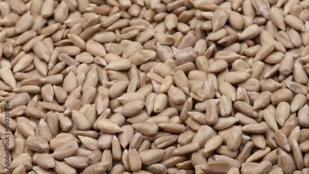 Peeled sunflower seeds, rotation in circle. A raw sunflower seeds, Turning. selective focus.
Peeled sunflower seeds, rotation in circle. A raw sunflower seeds, Turning. selective focus.