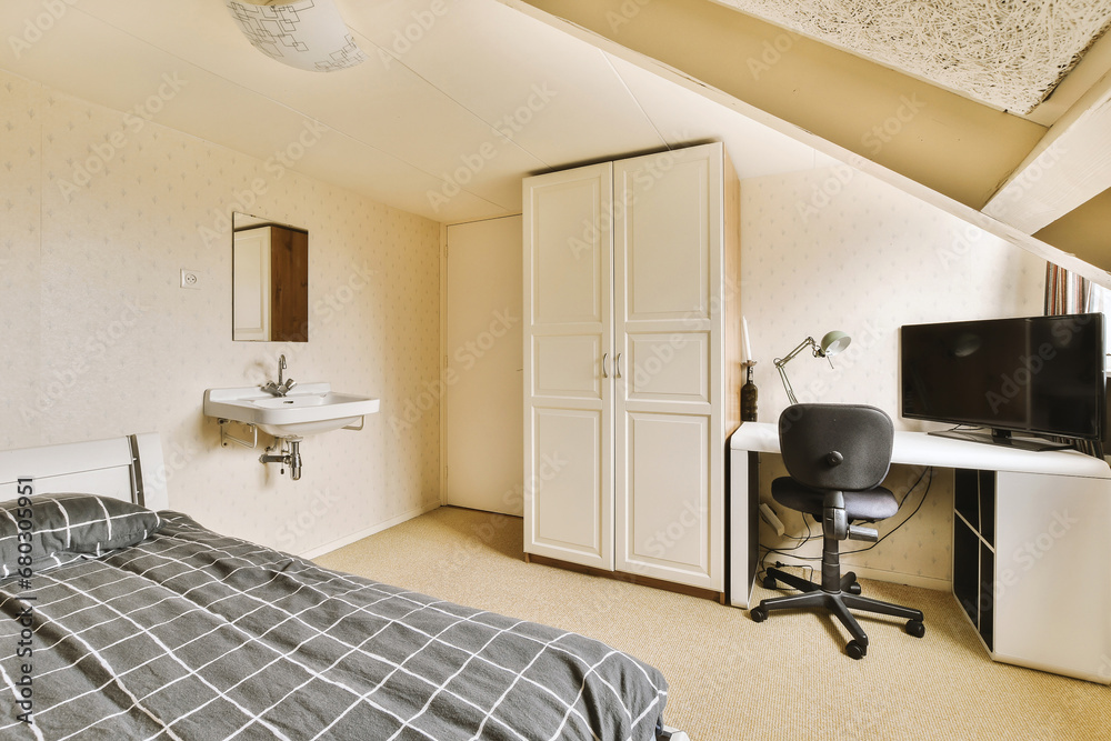 Bedroom with bed and closet by workspace Bedroom with bed and closet by workspace