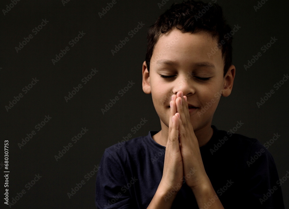 boy praying to God with hands held together with people sock image stock photo boy praying to God with hands held together with people sock image stock photo
